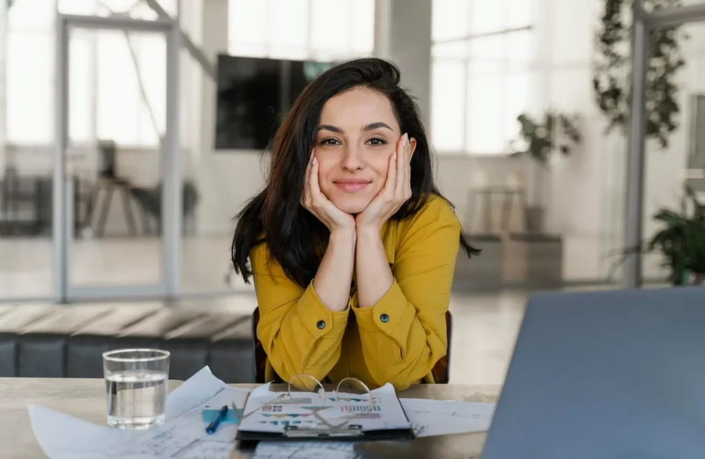 portrait smiley businesswoman her desk scaled